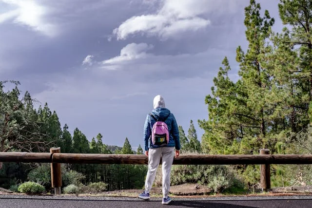 Solo traveler with backpack waiting at airport departure gate, ready for first solo adventure