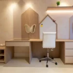 Modern small teenage bedroom setup with a minimalist wooden study desk, white chair, wall-mounted shelves, and soft lighting designed for a compact stylish room.