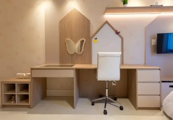 Modern small teenage bedroom setup with a minimalist wooden study desk, white chair, wall-mounted shelves, and soft lighting designed for a compact stylish room.